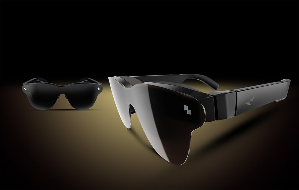 Two pairs of futuristic sunglasses, one in the foreground, the other in the background