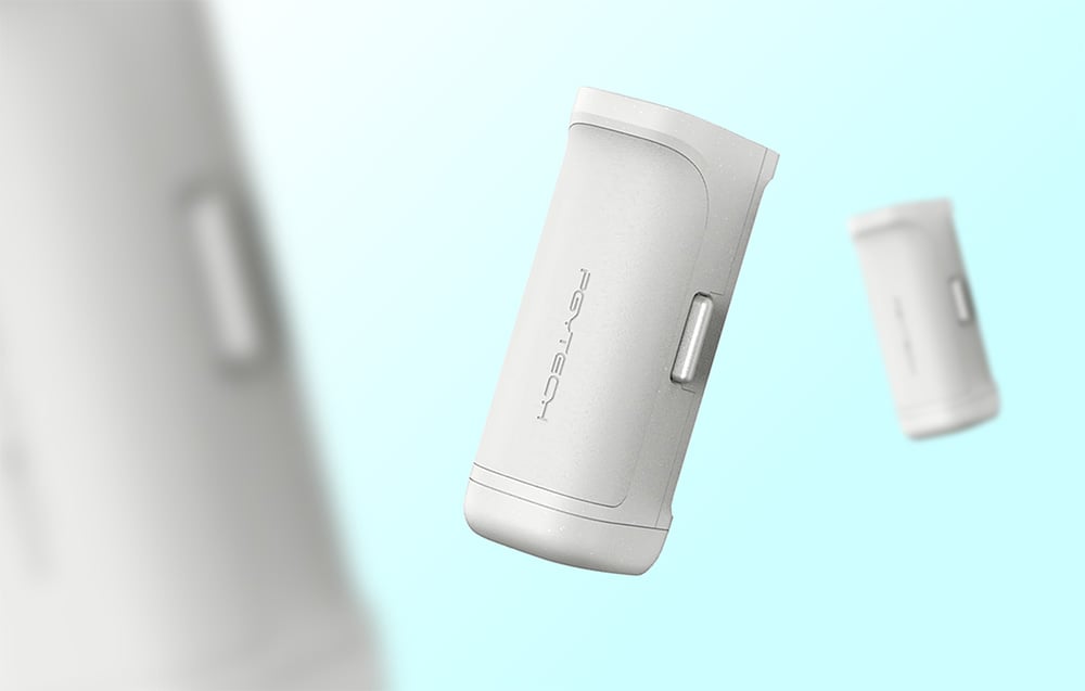 Hand holds iPhone in beige case with MagSafe powerbank and wrist strap, rear view of phone