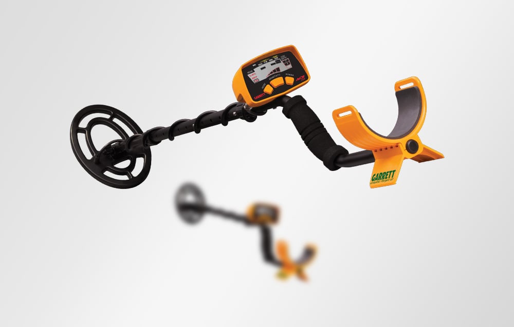 The Garrett ACE 150 metal detector seen from the side with a blurry second model in the background.