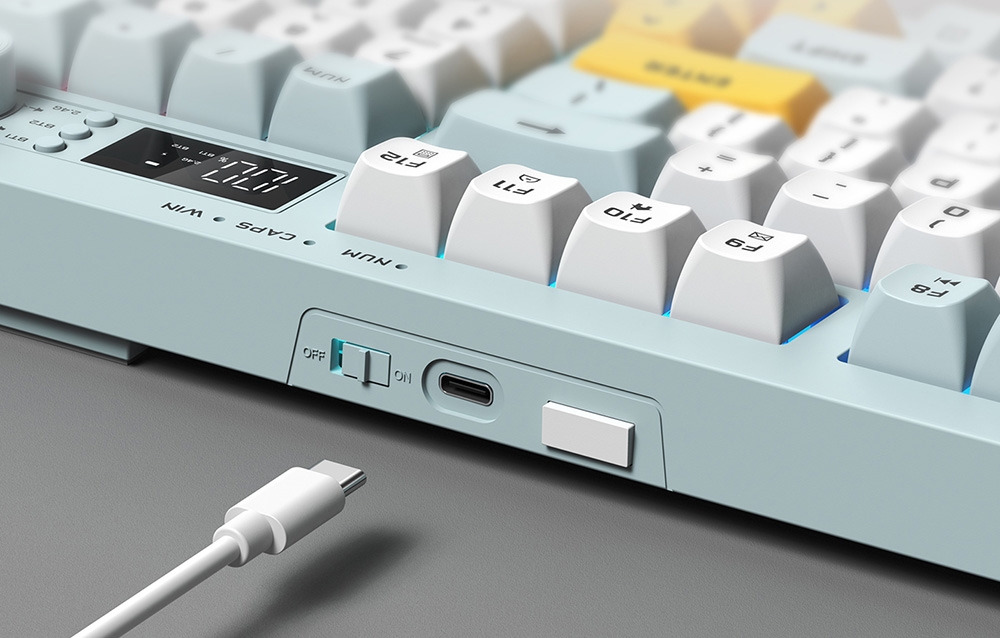 Excerpt of keyboard with USB-C port and white cable on gray background