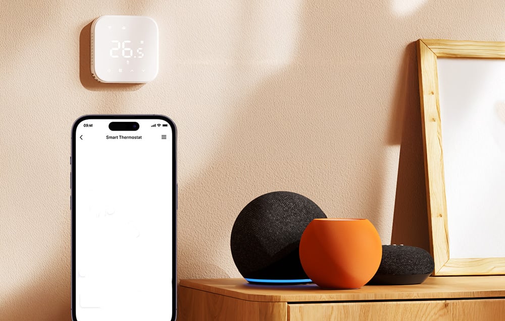 Smartphone with thermostat app, smart speakers and white wall thermostat displaying 26.5°C
