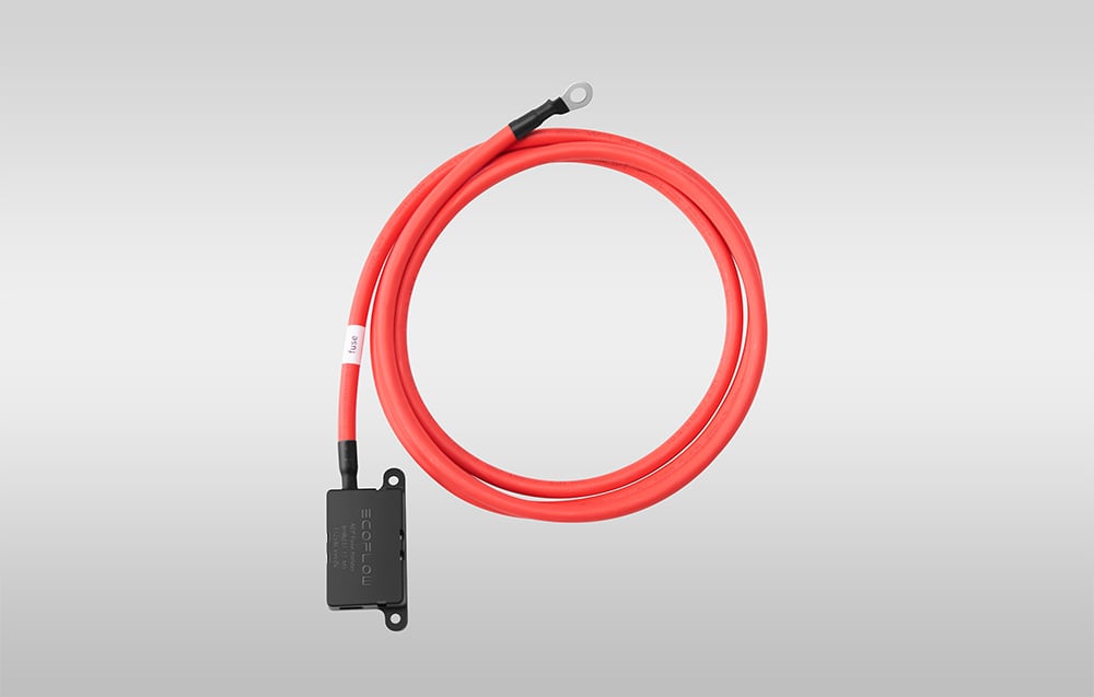 Coiled red cable with a black module on a gray background