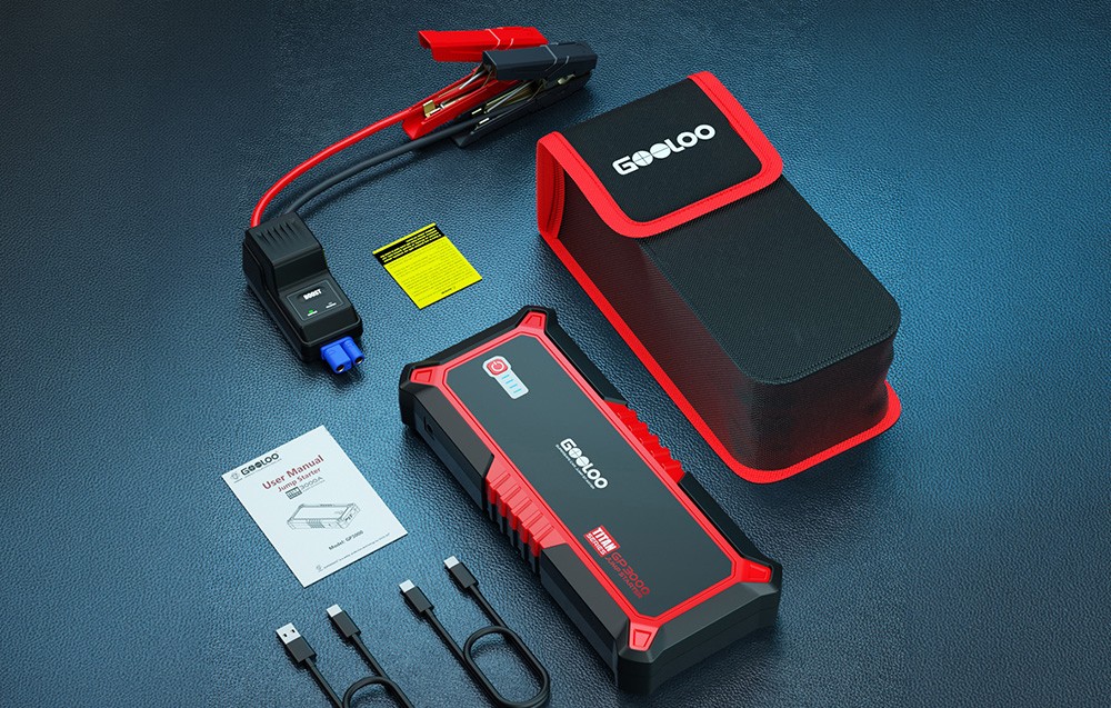 Car jump starter kit with a case, cables, and instructions on a surface