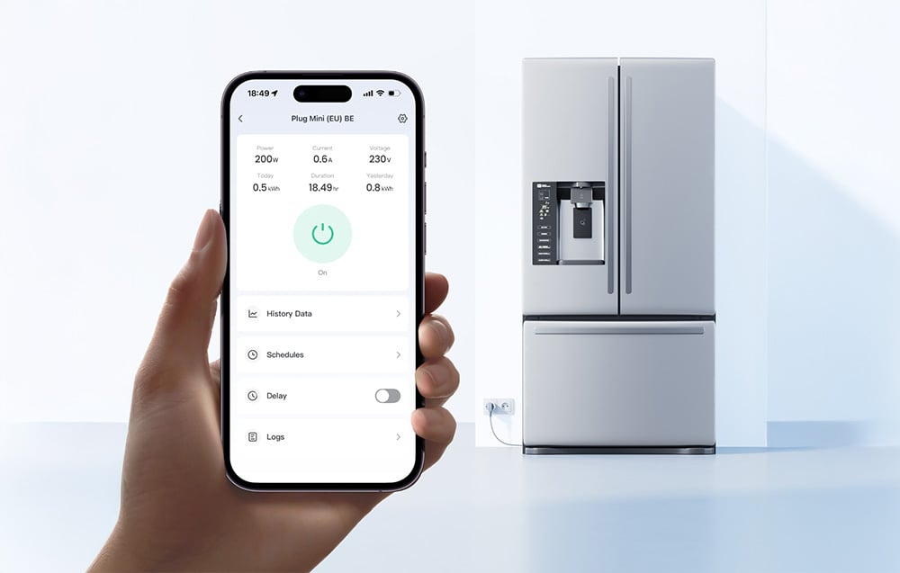 Smartphone held in hand, refrigerator plugged into power in background