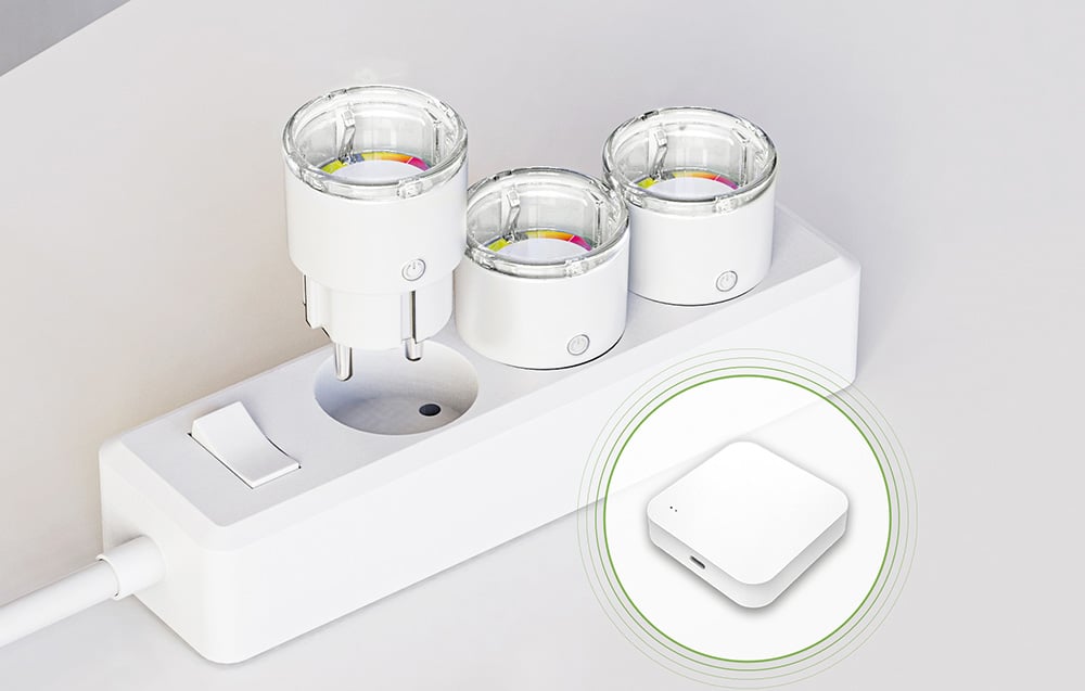 Three smart sockets plugged into a power strip, with a white control module visible next to them