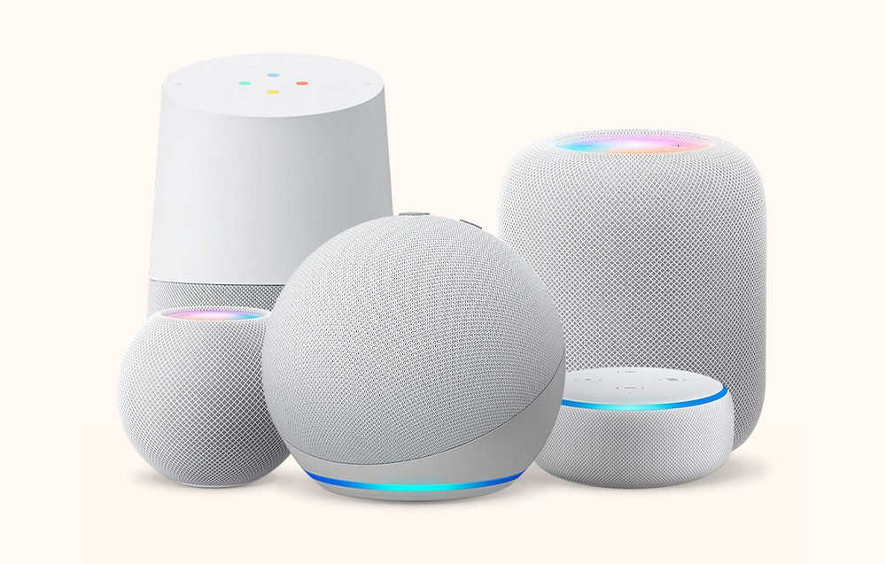 Various models of smart voice assistants on a light background