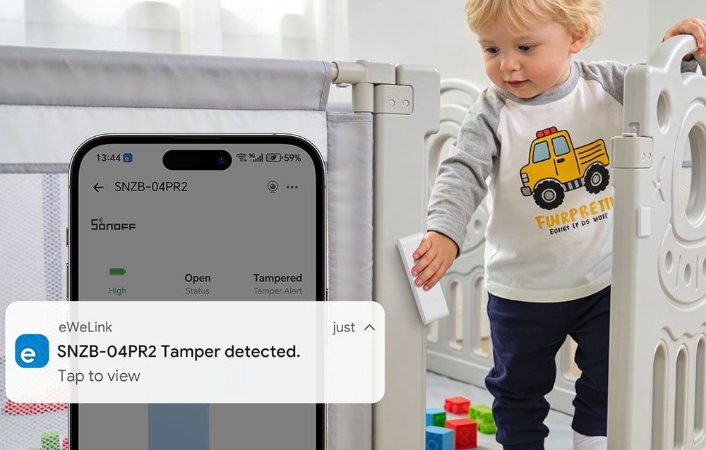 A boy climbing out of his crib, next to a smartphone with notifications enabled