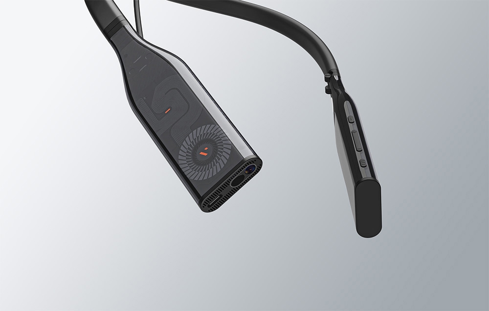 Close-up detail of a black neckband device with visible pattern and buttons on the sides