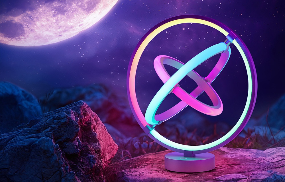 A round desk lamp glowing in colorful hues, placed on a rock against a backdrop of a night sky with a large moon.