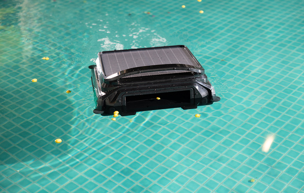Wybot F1 robot cleaning the pool with leaves on the bottom among debris