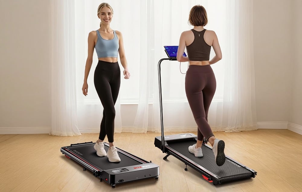 Two women in tracksuits on treadmills in a bright room