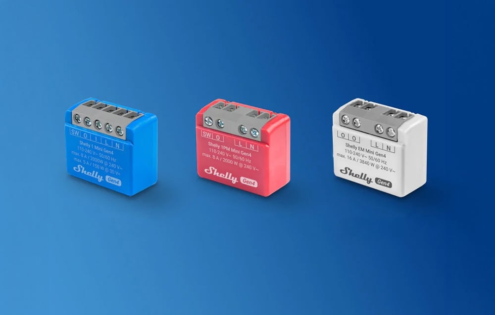 Three rectangular Shelly energy meters in blue, red, and white arranged side by side on a blue background.