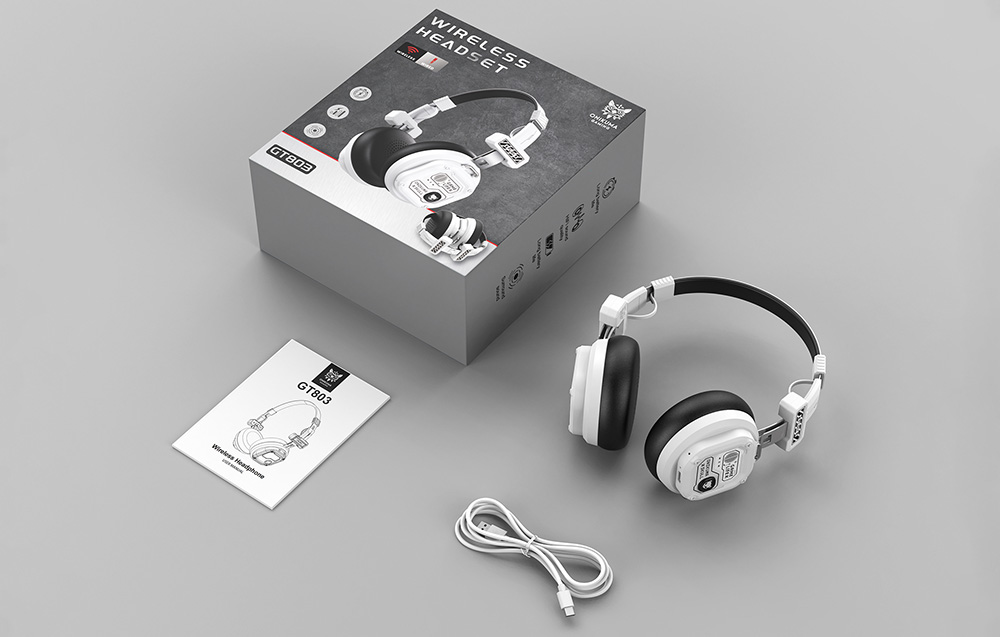 Onikuma headphones lying on a gray table next to a box and USB cable