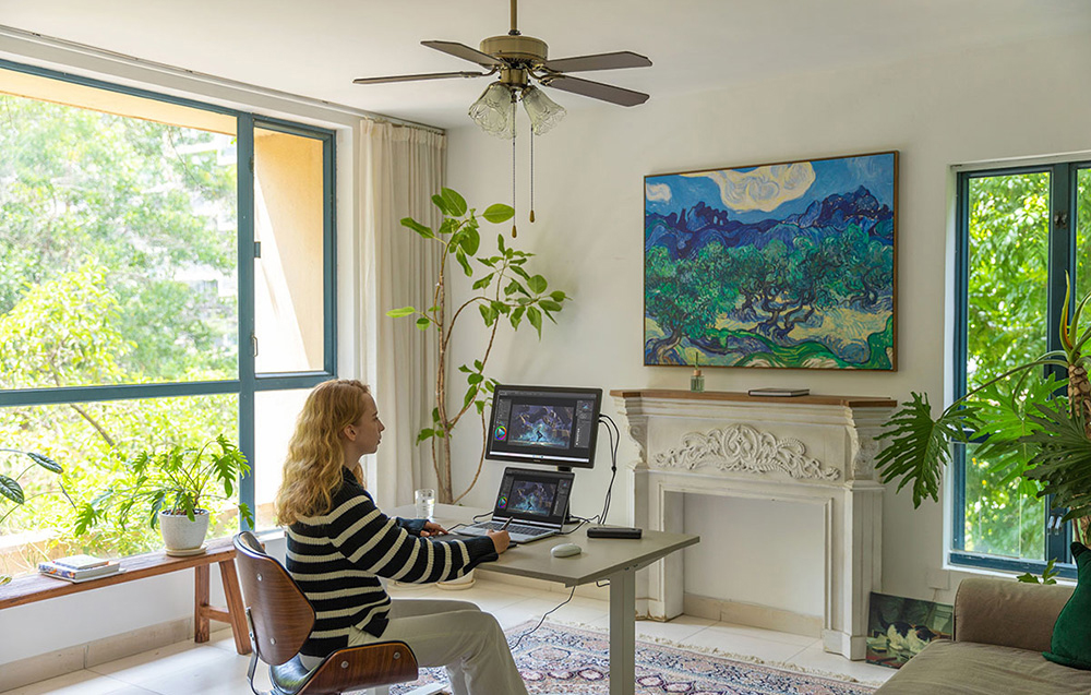 Home workstation with Huion graphics tablet connected to a laptop computer