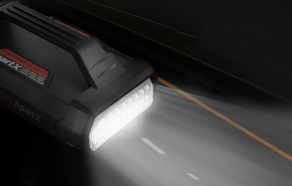 Portable device with a powerful flashlight turned on, illuminating the road at night.