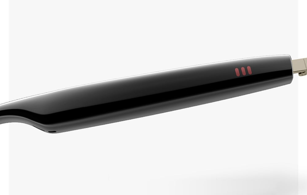Close-up of a black, glossy glasses temple with three red indicator lights.