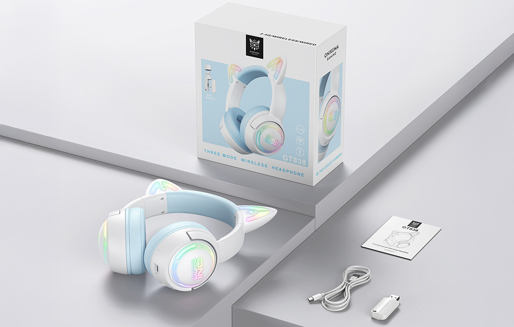 Box, USB cable, adapter, user manual and Onikuma headphones lying side by side on a gray table