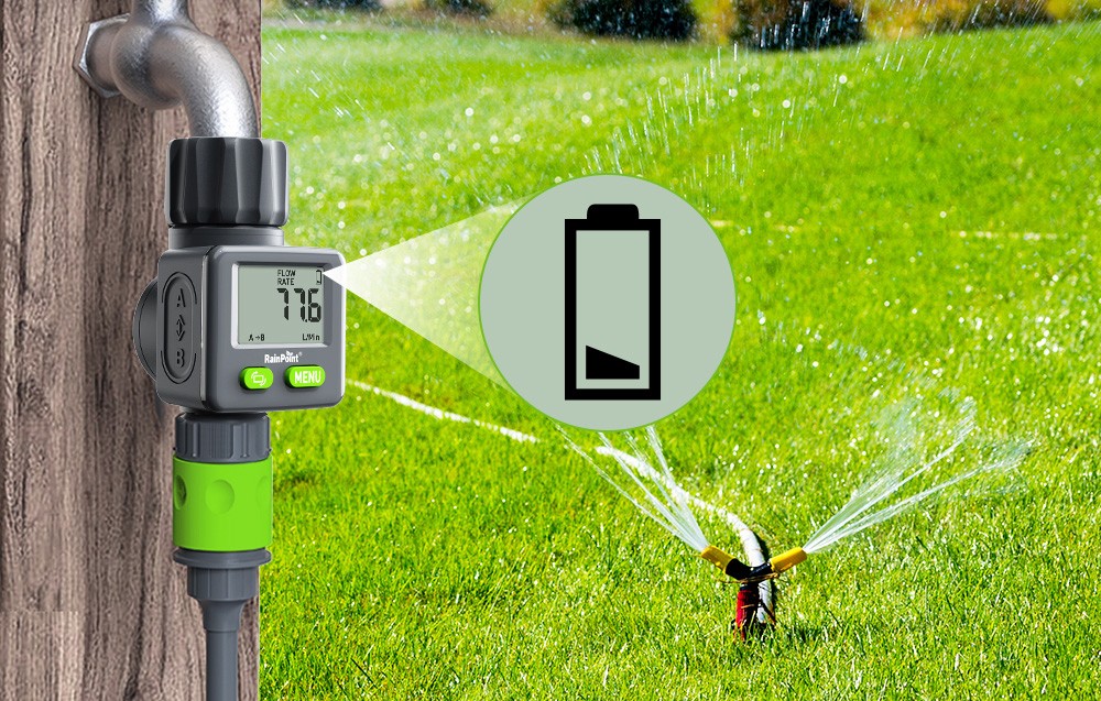 RainPoint meter showing water flow in liters per minute, with low battery icon and sprinkler running in the background.