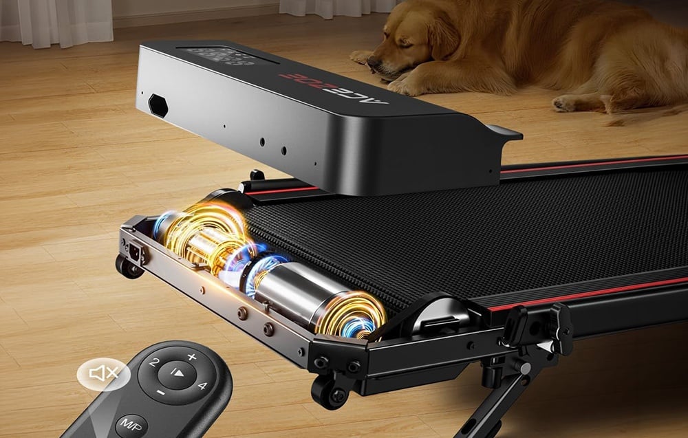 Close-up of the treadmill’s internal components, with a remote control next to it; in the background, a dog is sleeping on the floor