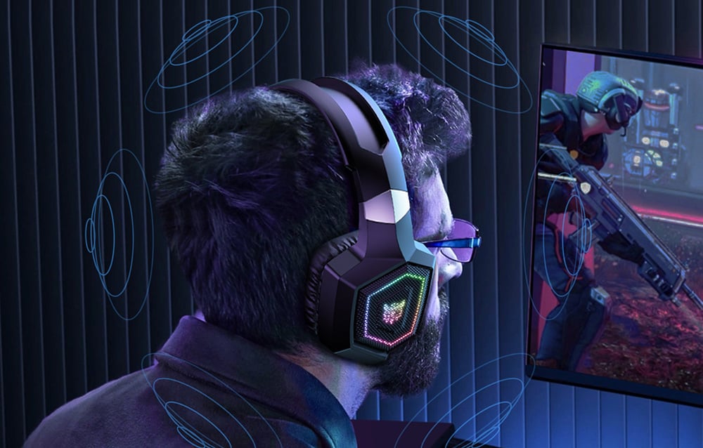 A man playing an FPS type game wearing Onikuma headphones and glasses