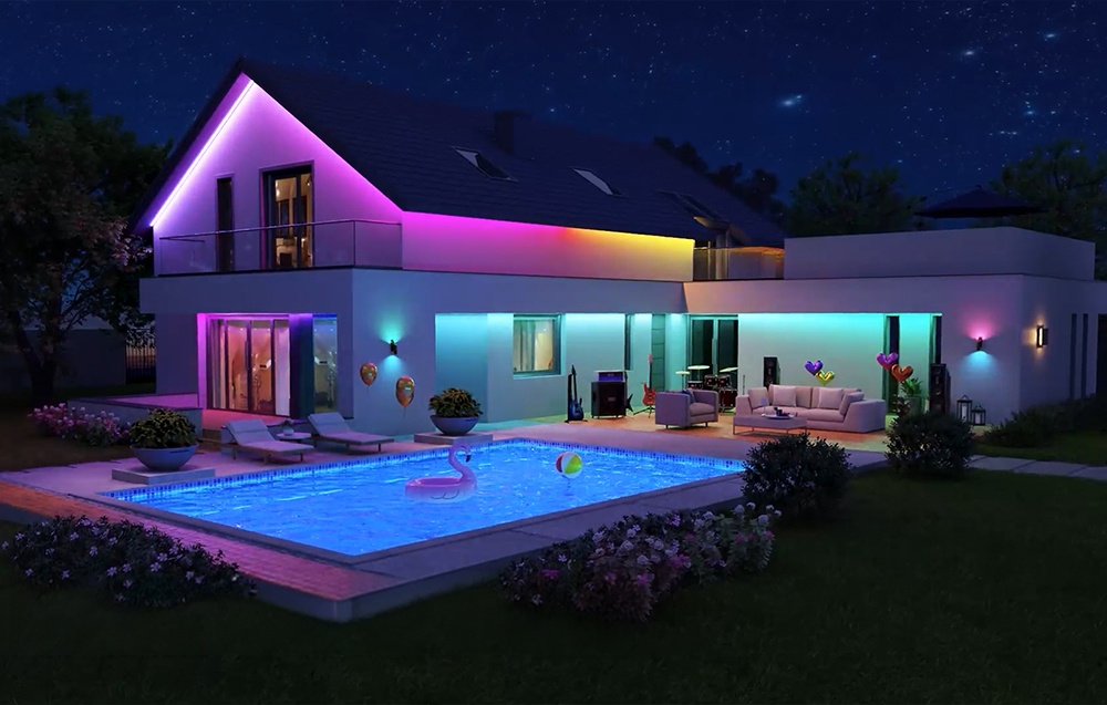 A modern house with a pool illuminated by LED strips.