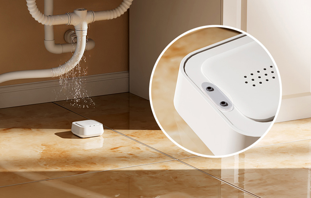 MEROSS smart water leak sensor lying under the sink, from which water is flowing