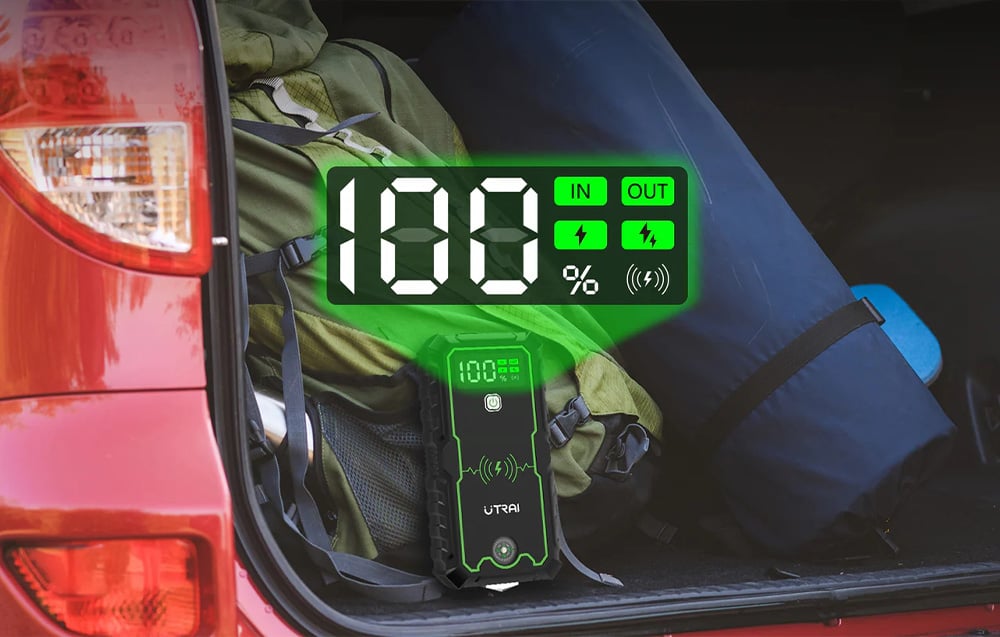 The device’s digital display showing a 100 percent charge level in the car’s trunk.