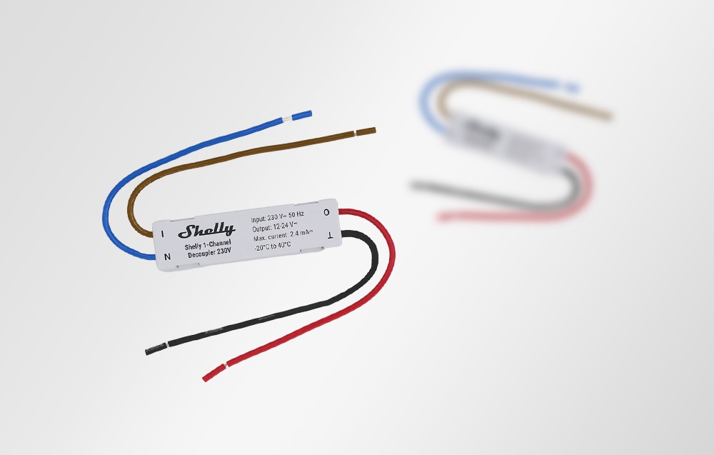 Two Shelly 1-Channel Decoupler modules, one in the foreground, the other blurred in the background