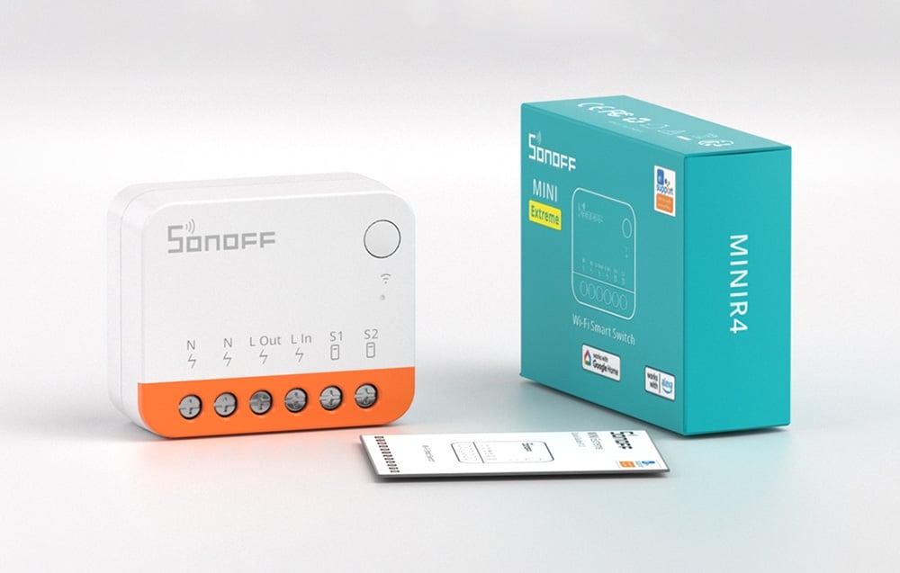 Sonoff switch on a light-colored table next to the user manual and packaging