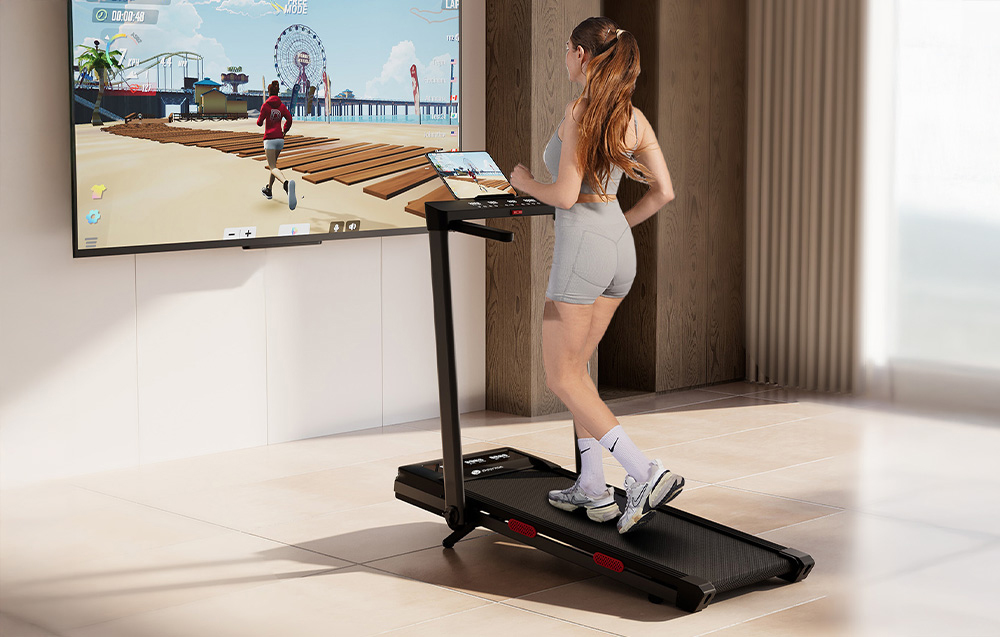 Person in shorts running on a black treadmill during a virtual workout on a large screen