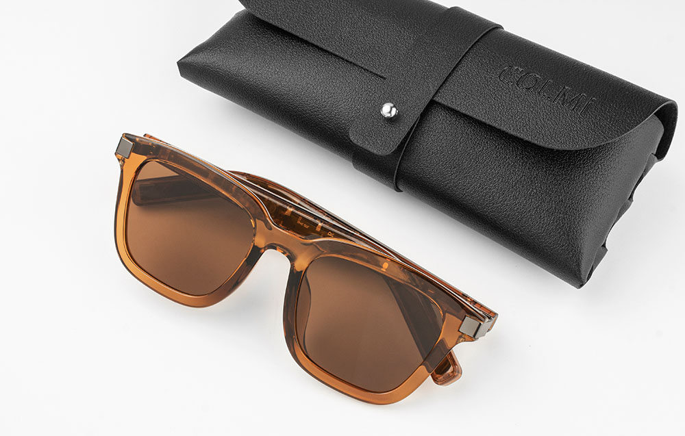 COLMI smart glasses lying next to a dedicated black eco-leather case on a white background.