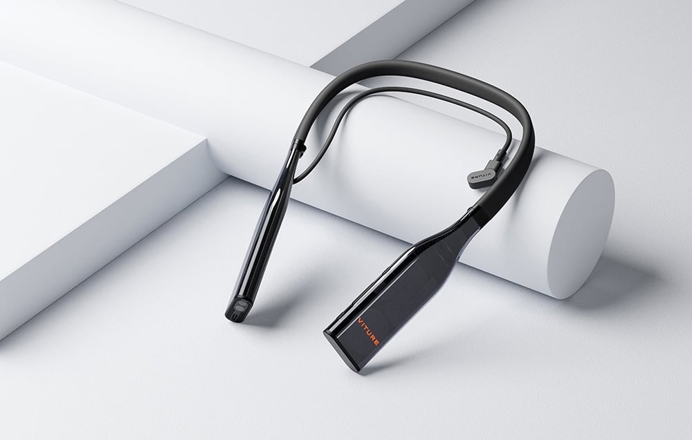 A black VITURE brand neckband device with cable and headphones lies on a white geometric surface