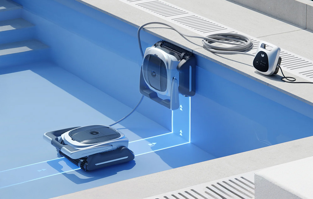 A pool robot climbs the pool wall, heading toward the power module located on the edge