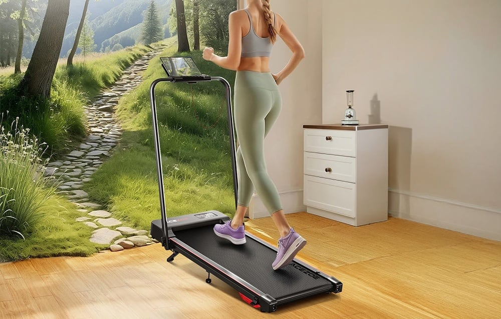 A woman in a green tracksuit on a treadmill in a bright room, with a forest landscape in the foreground