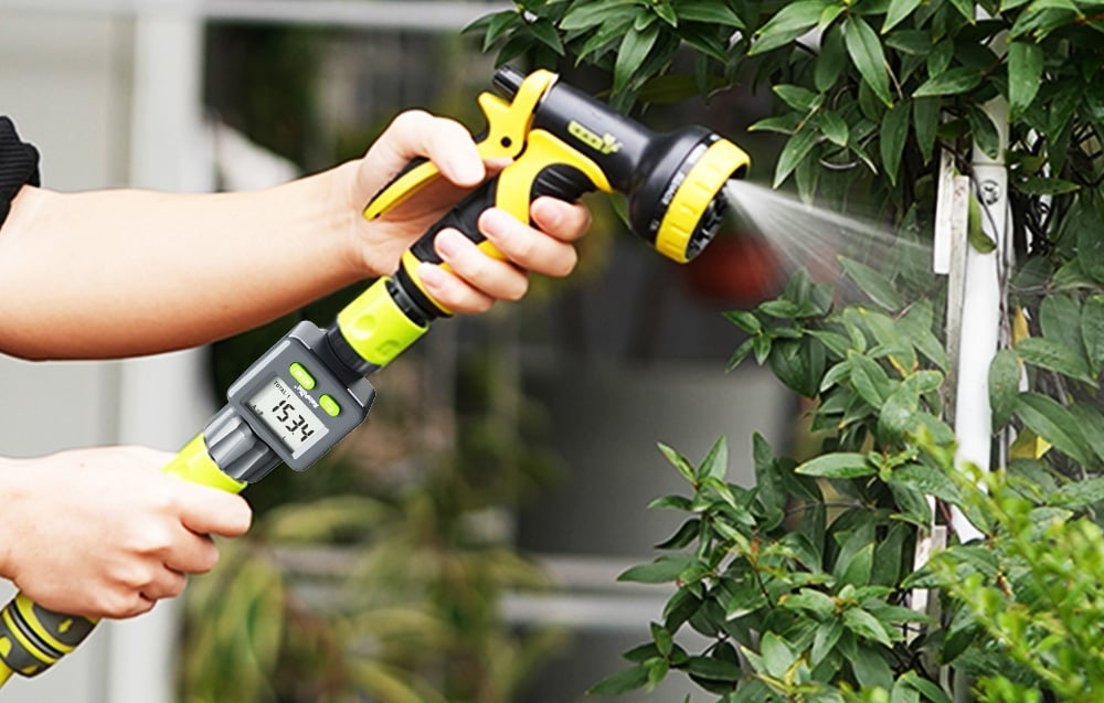 RainPoint flow meter installed on the garden hose when hand watering plants with a sprinkler gun.