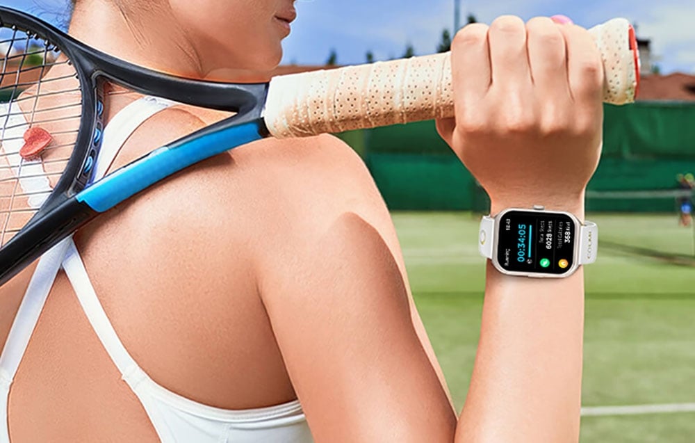 A woman with a tennis racket in her hand and a smartwatch on her wrist.