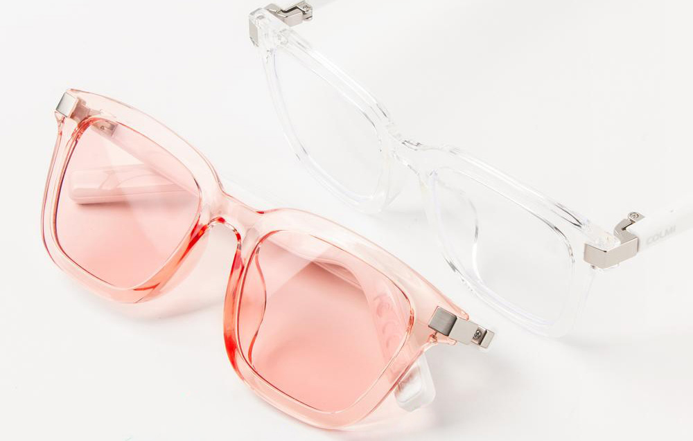 Pink and transparent glasses lying on a light background