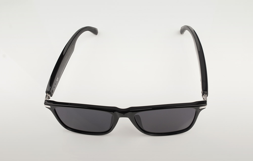 Black smart glasses viewed from above, showing the frame design and wide temples.