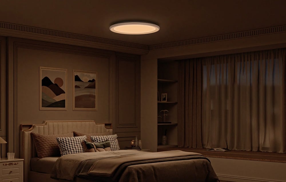Yeelight Mars C400 ceiling lamp shining warm light in a bedroom.