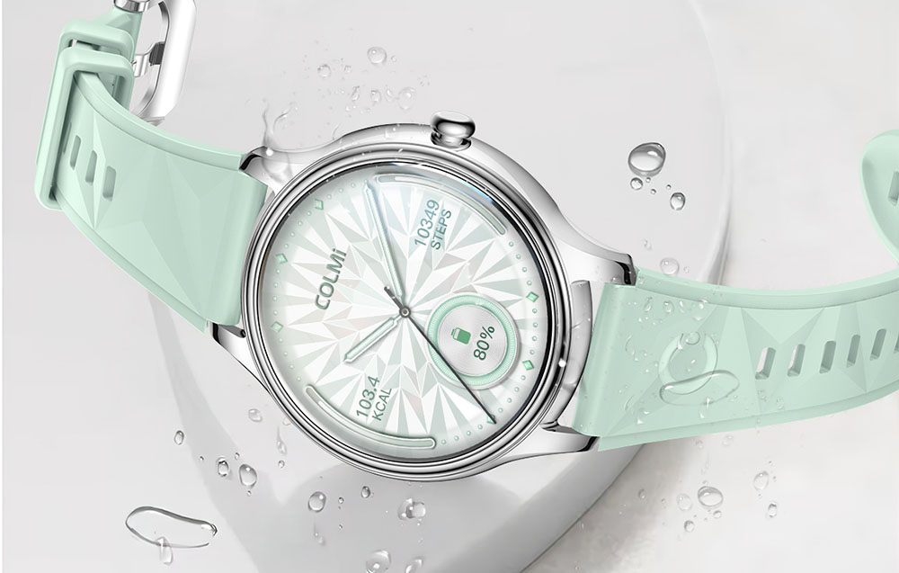 Silver COLMI smartwatch with a mint strap with a geometric pattern, displaying the number of steps and battery level on the dial against a water drop background