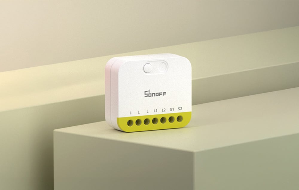Two-channel Sonoff mini switch on a green platform