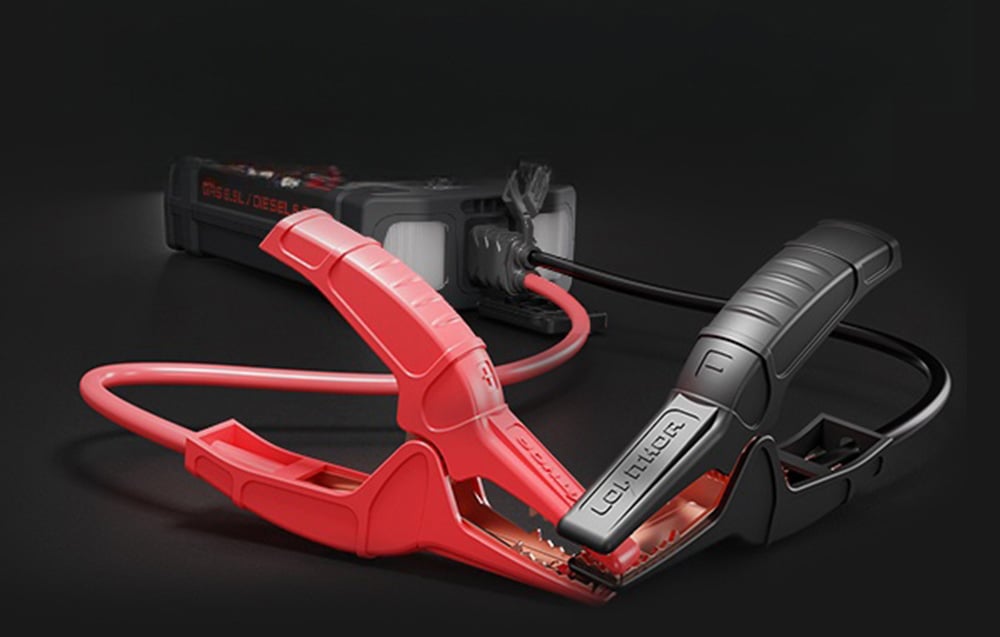 Red and black clamp with thick cables connected to the back of the jump starter.
