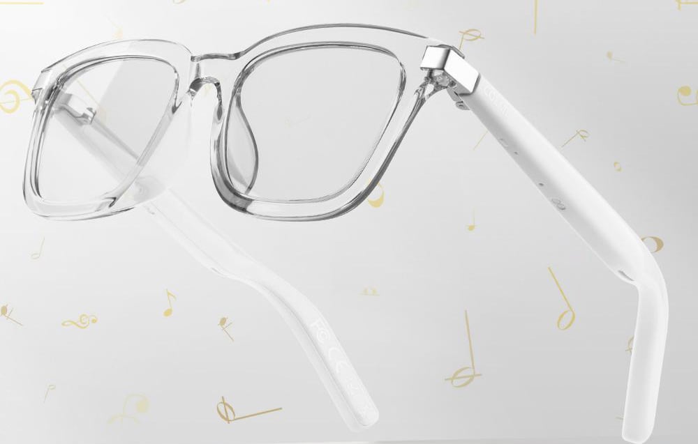 Transparent glasses on a gray background with gold notes