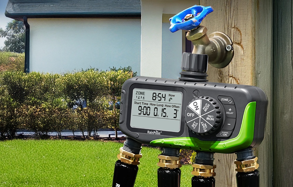 RainPoint 4-zone irrigation controller connected to an outdoor faucet, with 4 hoses connected to it at the bottom in the garden