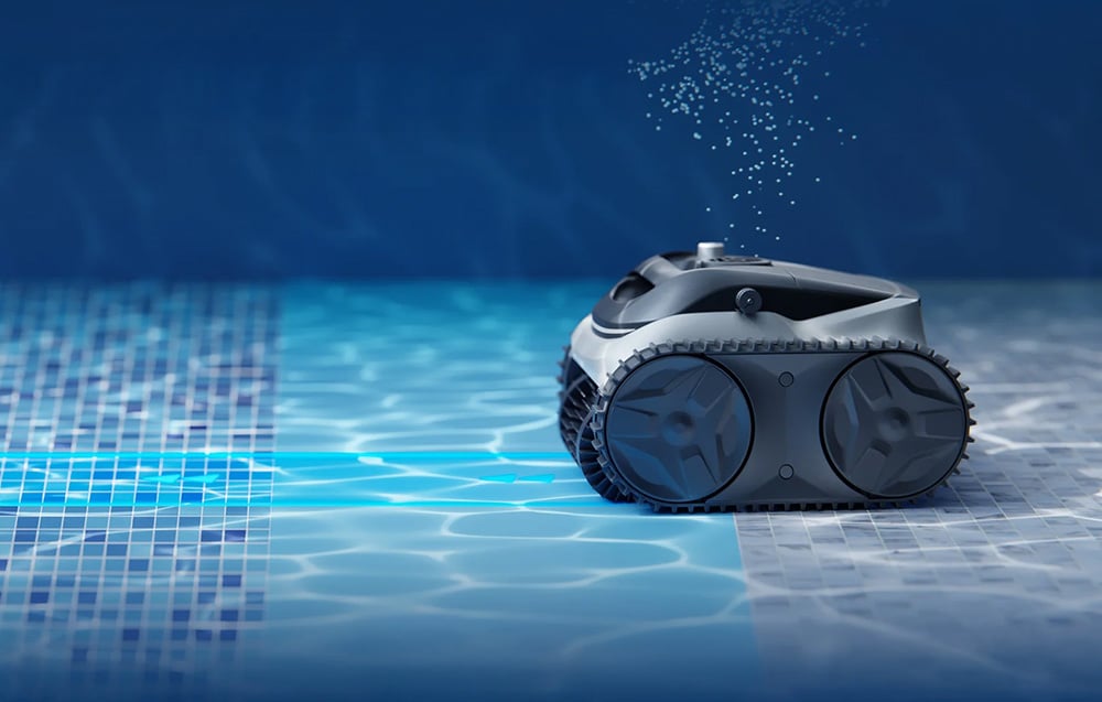 The pool robot moves along the bottom of the pool, leaving a trail of tiny air bubbles behind it