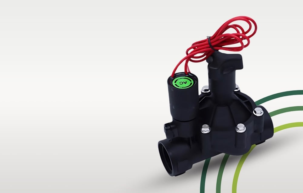 Black irrigation solenoid valve with red wire and visible from the front on a bright background with colored lines