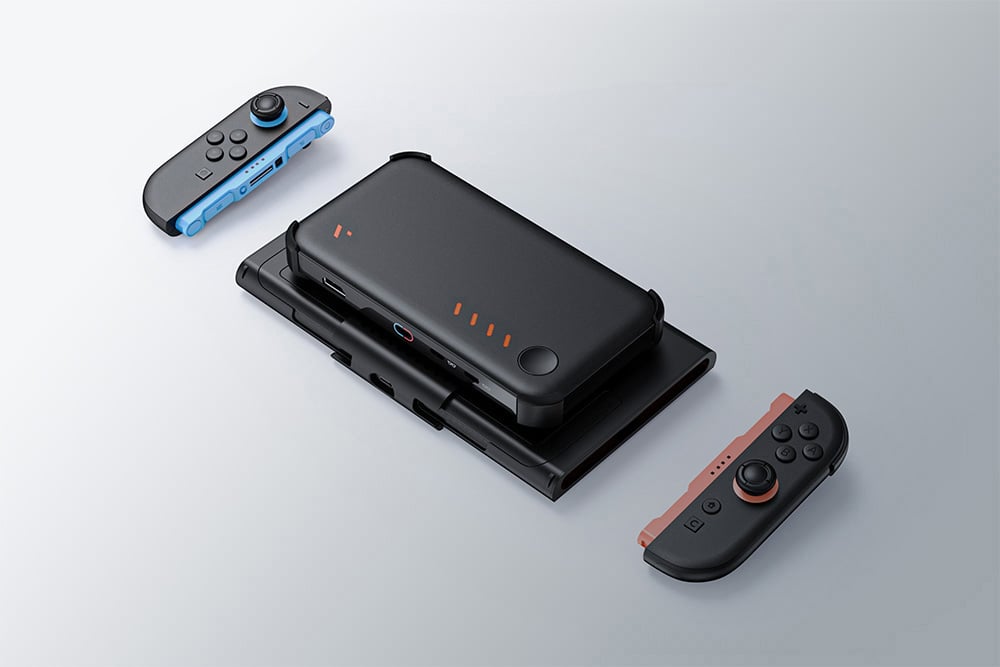 Black holder with attached powerbank and detached console controllers floats over bright surface