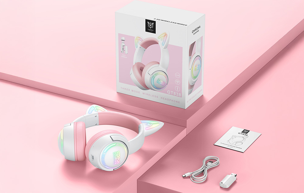 Box, USB cable, adapter, user manual and Onikuma headphones lying on a pink table