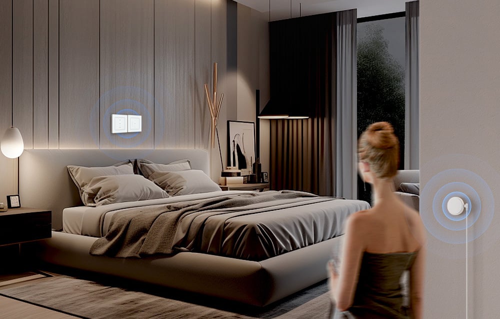 A woman with bundled hair enters a room where a lamp is lit