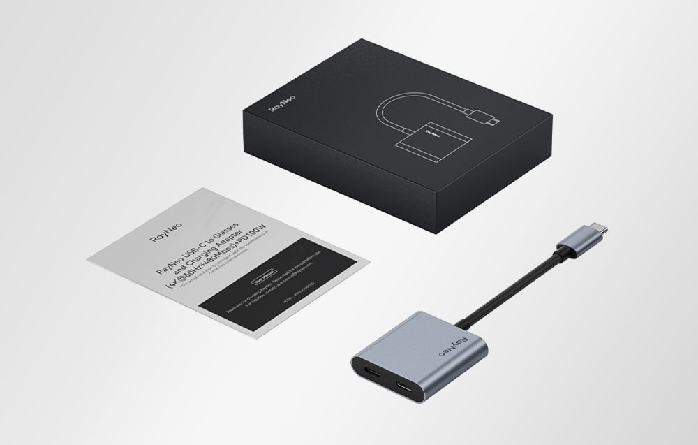 RayNeo USB-C adapter with cable and instructions next to the package, shown in bright background.